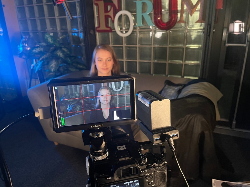 Kara being recorded for a gofundme video for Petalled Apologies.